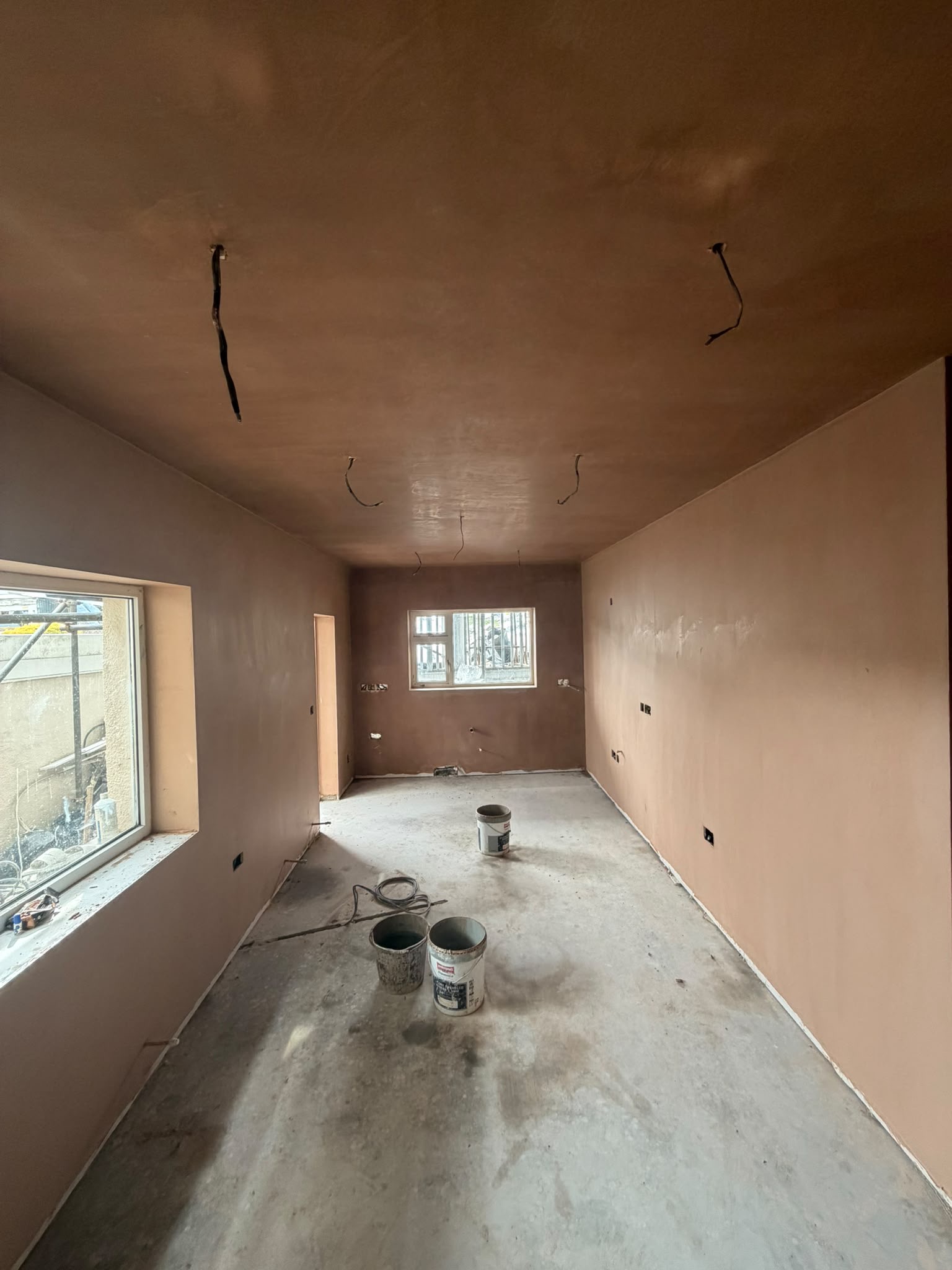 Large room showing plastering work across the walls and ceiling