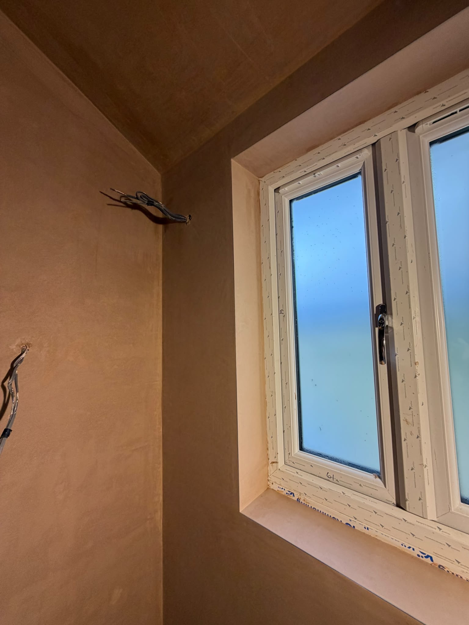 Fresh plaster around a window reveal