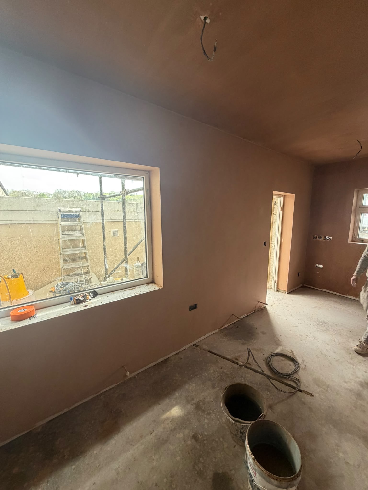 Long hallway with plastered walls